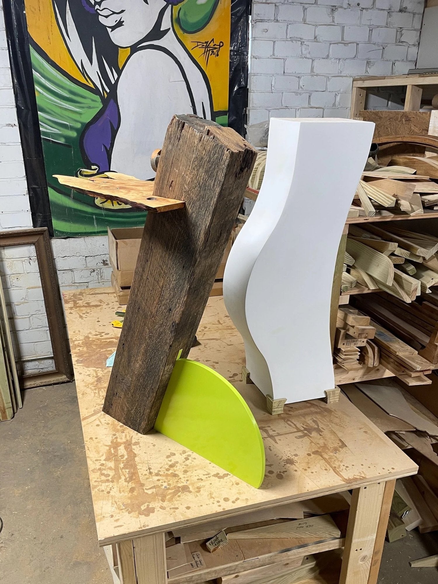 Reclaimed timber, a bright green curve and a white sculptural form on Ric’s workbench